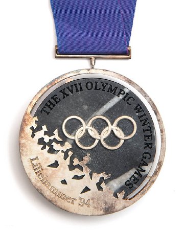 Front: Lillehammer 1994 silver medal, Olympic rings over granite