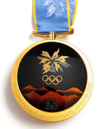 Back: Nagano gold medal, Olympic emblem and mountains, cross-country ski