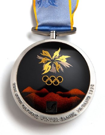 Back: Nagano silver medal, Olympic emblem over mountains, luge