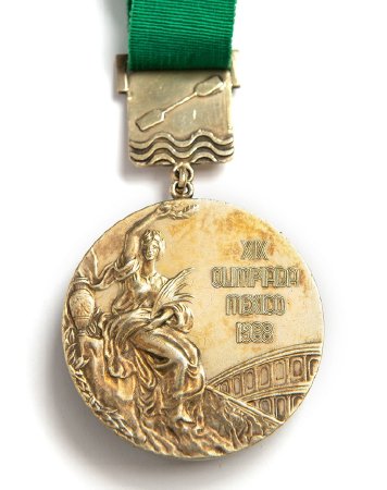 Front: Mexico City 1968 gold medal, Victory with rowing pictogram