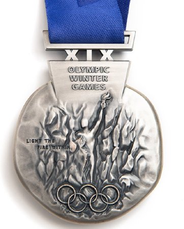 Front: Salt Lake 2002 silver medal, athlete, Olympic rings and legend