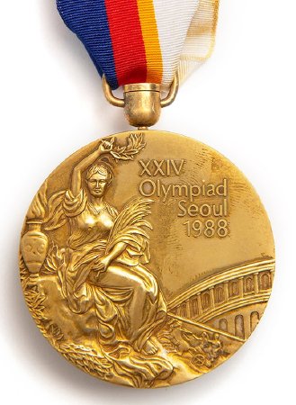 Front: Seoul 1988 gold medal, Victory and Colosseum in background