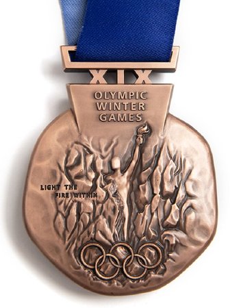 Front: Salt Lake 2002 bronze medal, athlete, Olympic rings and legend