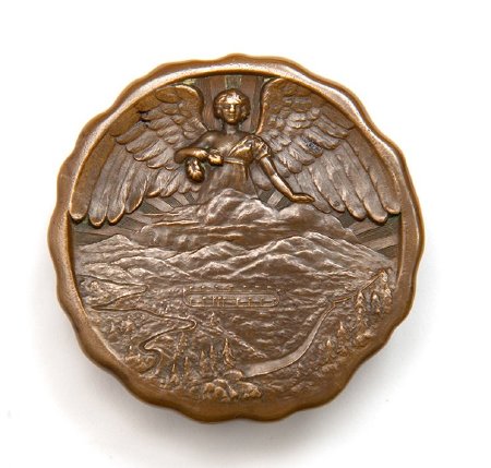 Front: Lake Placid 1932 bronze medal, Nike above Adirondacks and venues