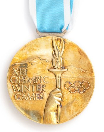 Front: Lake Placid 1980 gold medal, hand holding torch with legend