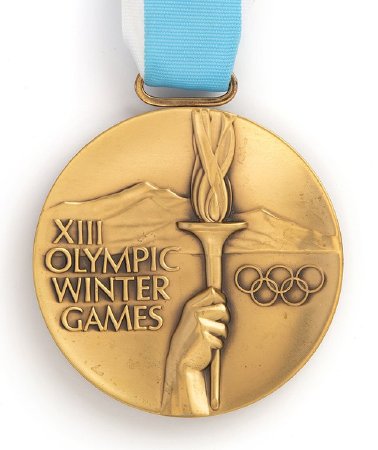 Front: Lake Placid 1980 bronze medal, hand holding torch with legend